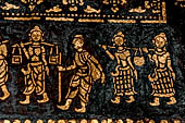 Wat Xieng Thong temple in Luang Prabang, Laos. Detail of the  intricate gold stencilling on black lacquer that decorate the walls of the sim. 